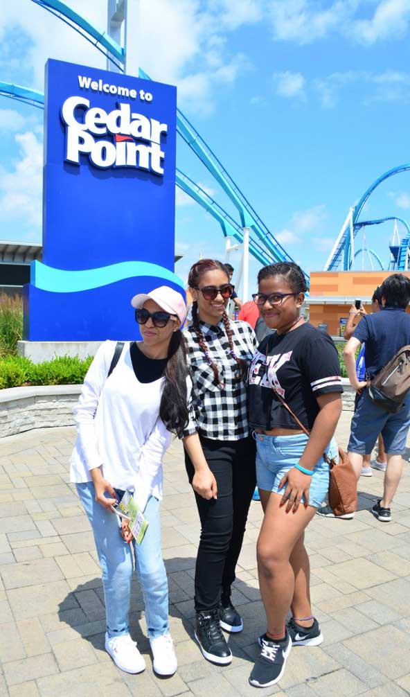 a group of students pose at an amusement park