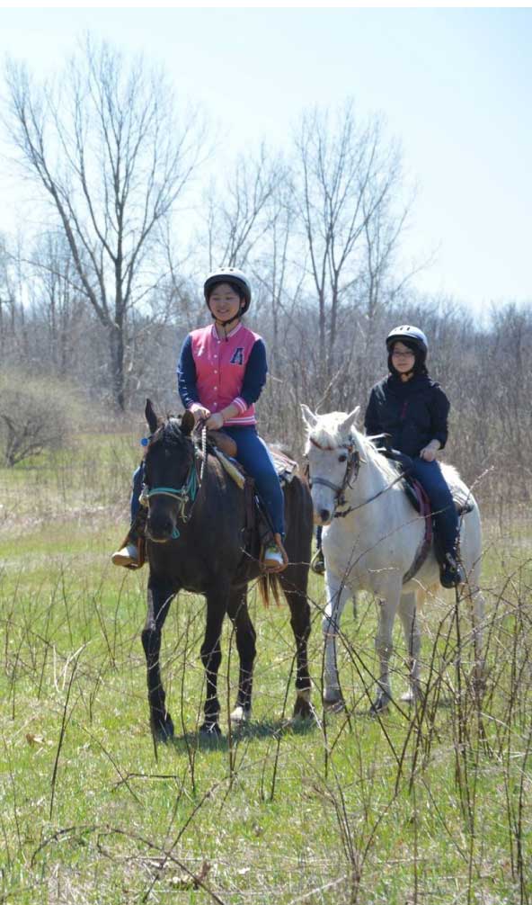 two people ride horses