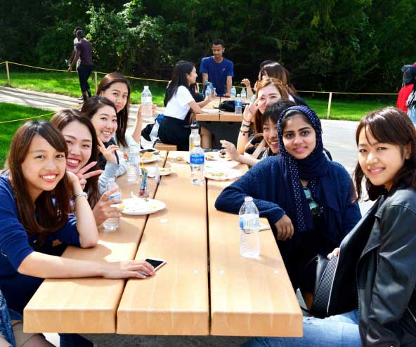 a large group of students at a picnic table