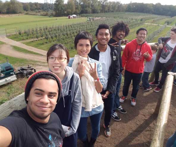 a group of smiling people outside