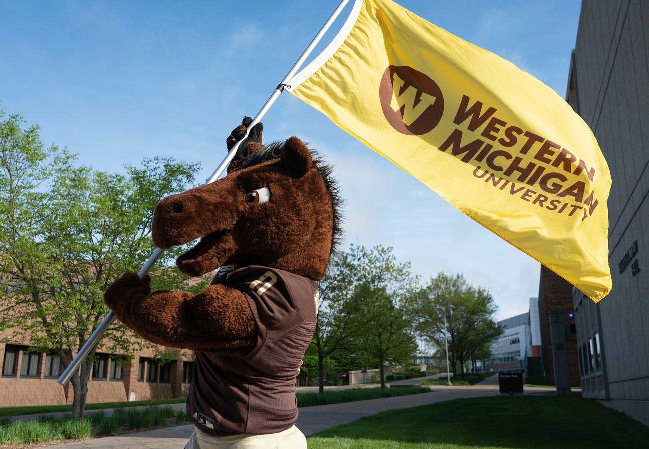 bronco mascot holding a WMU flag