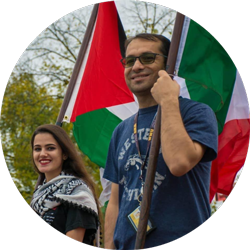 two people hold flags from different nations